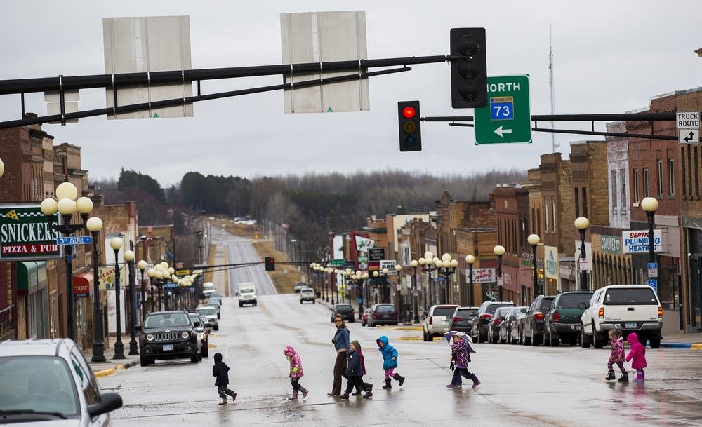 Children cross the street in downtown Chisholm.
