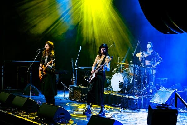 A band performing onstage in a music venue