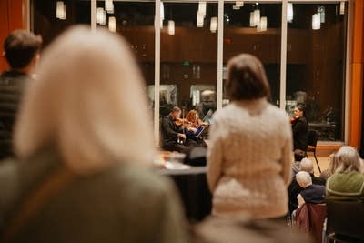 A quartet performing in an auditorium