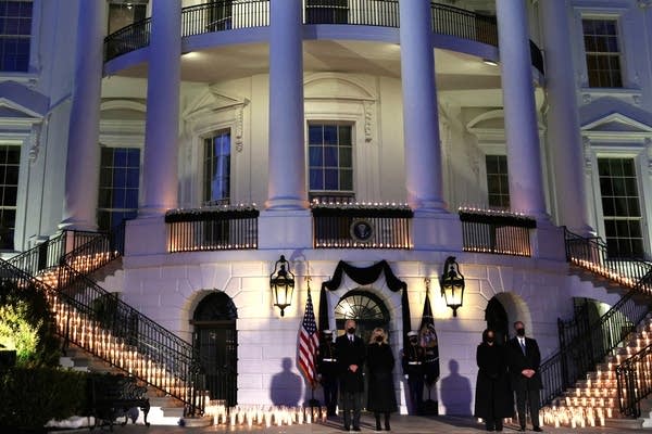 U.S. President Joe Biden, first lady Jill Biden, Vice President Kamala Harris and husband, Doug Emhoff, participate in a moment of silence at sundown in the South Portico of the White House February 22, 2021 in Washington, DC. 
