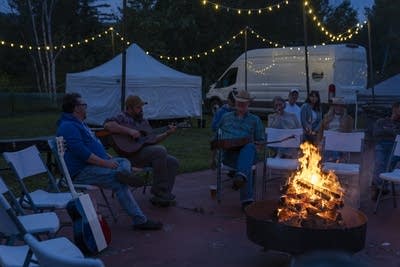 Crowd gathering around a campfire