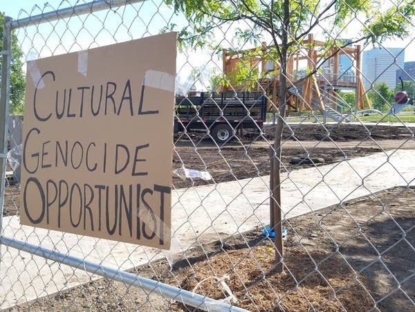 Signs of protest against the work "Scaffold" at the Walker Art Center