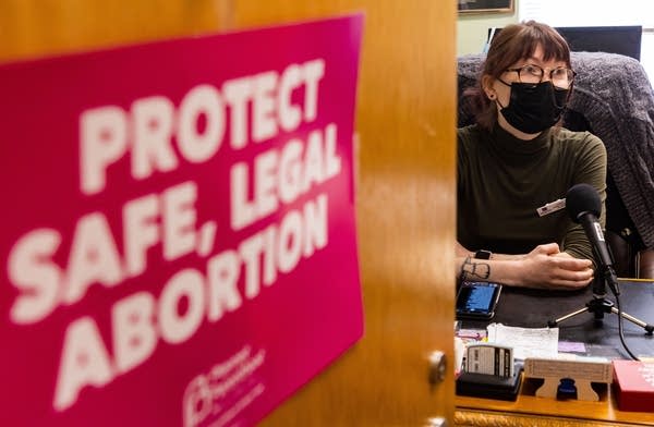 An office door has a poster that reads "Protect Safe, Legal Abortion"