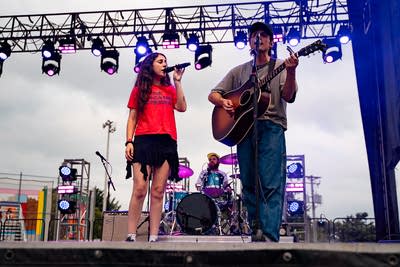 Samia performing on an outdoor stage.