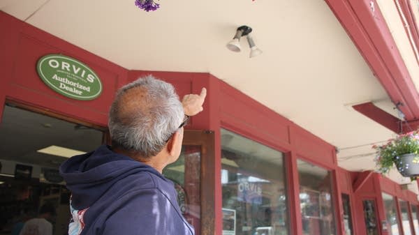 Property owner Turk Montepare points at his non-compliant lighting on his building