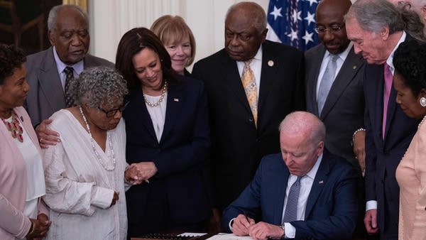 Vice President Kamala Harris and Opal Lee (second from left), the activist known as the grandmother of Juneteenth, watch as President Joe Biden signs the Juneteenth National Independence Day Act.
