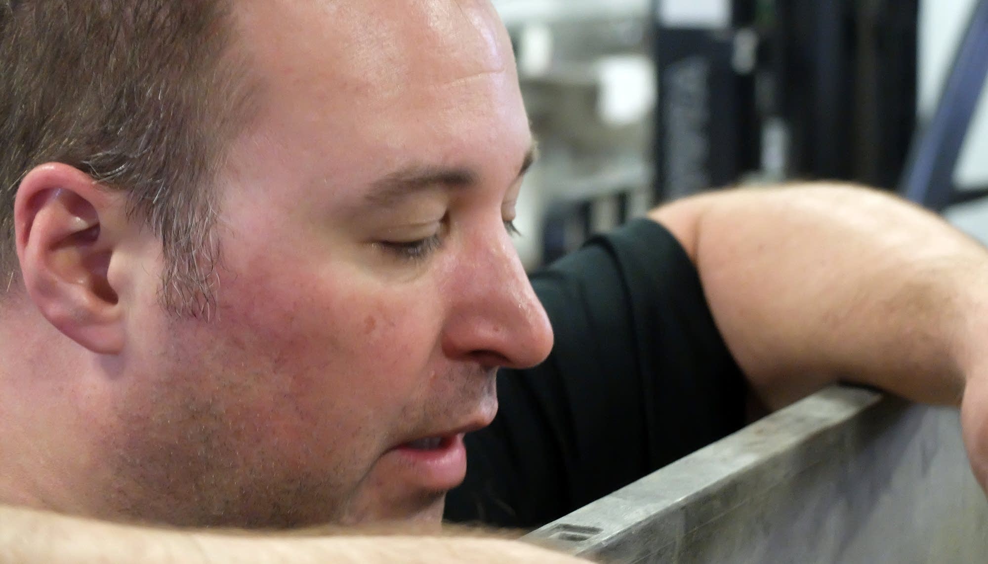 Mike Swanson looks into a tote of rye at Far North Spirits.