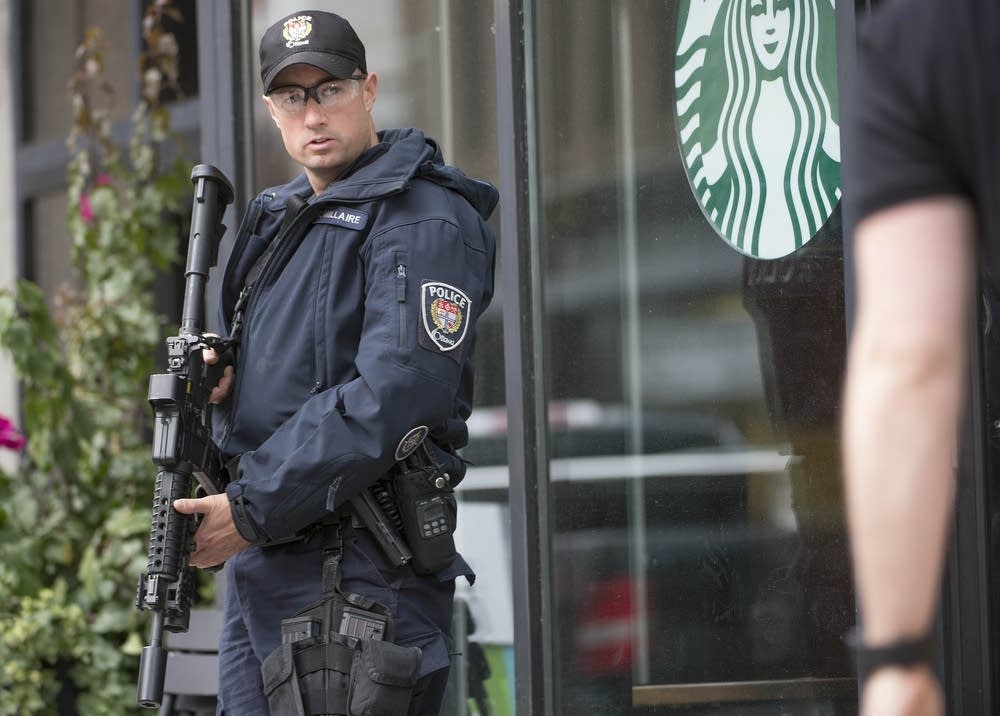 Police officer stands watch.
