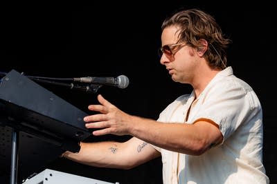 Passion Pit performing on an outdoor stage.