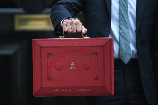 The U.K.'s Chancellor of the Exchequer Rishi Sunak holds up the red box containing the latest budget proposals outside 11 Downing Street in London.
