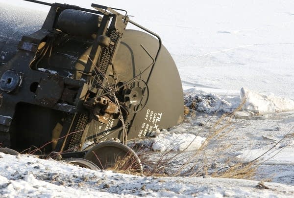 A rail car lays in the ice of the Mississippi.