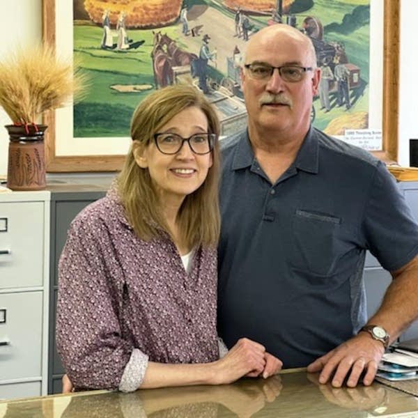a woman and a man pose for a photo
