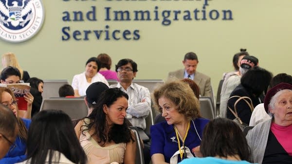 In this file photo, immigrants await their turn for green card and citizenship interviews at the U.S. Citizenship and Immigration Services (USCIS) Queens office on May 30, 2013 in the Long Island City neighborhood of the Queens borough of New York City.