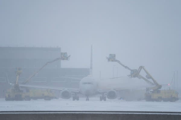 A  plane deiced during a snowstorm
