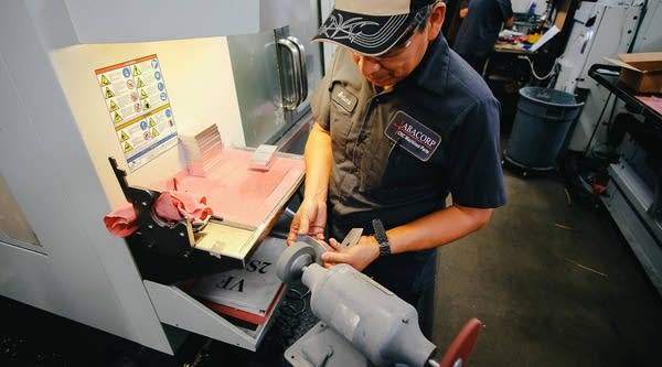An ABACORP employee works with machinery at the shop. The manufacturing company is one of many small businesses struggling to find more skilled workers.