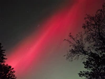 Red and green lights reach across the night sky.