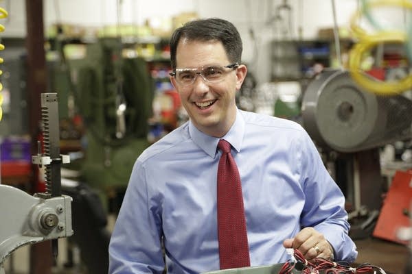 Wisconsin Governor Scott Walker signs budget as he launches his bid for the presidency