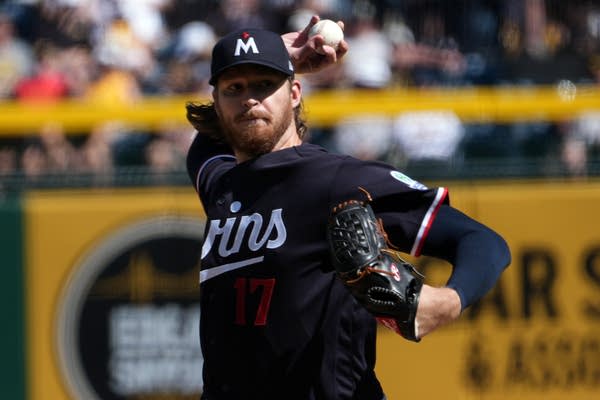 A pitcher prepares to release the ball mid-throw.