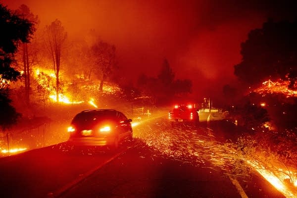 Embers fly across a roadway.