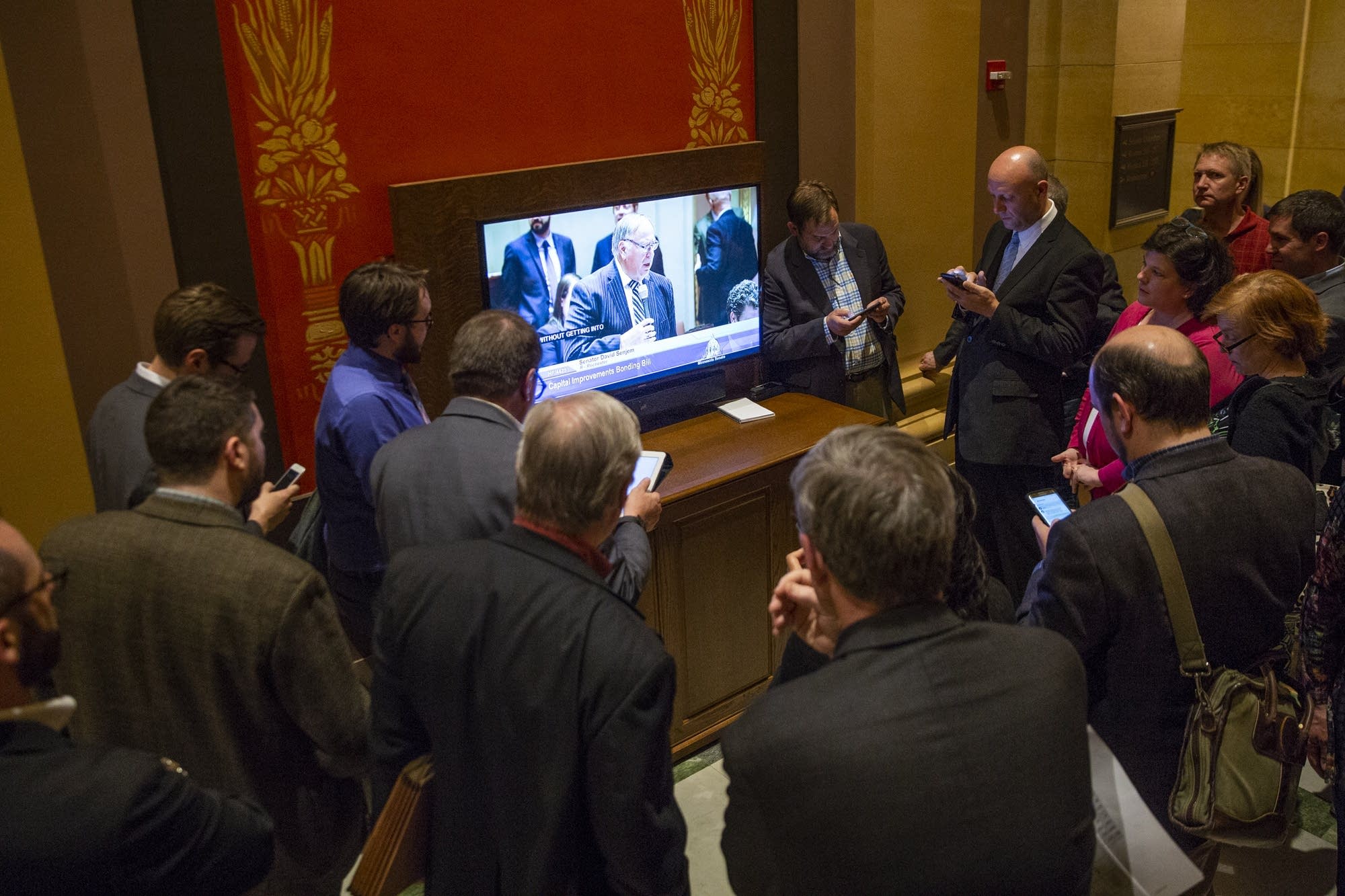 People gather to watch the Senate debate a bill.
