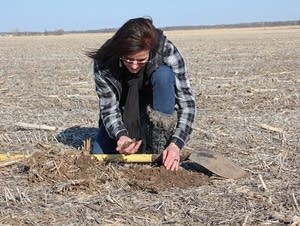 Deb Gangwish inspects soil on her farm near Shelton, Neb.
