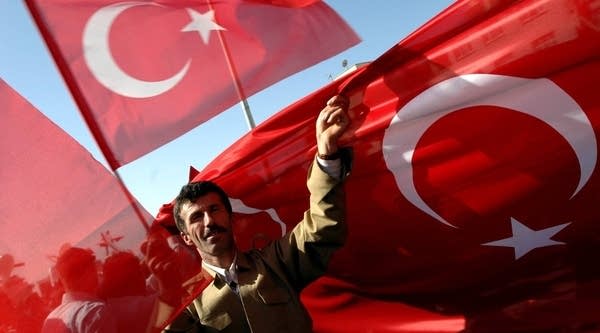 Protesters hold Turkish flags aloft and shout slogans against the outlawed Kurdistan Workers Party (PKK) on Oct. 27, 2007 in dowtown Sirnak city, Sirnak province, southeastern Turkey.