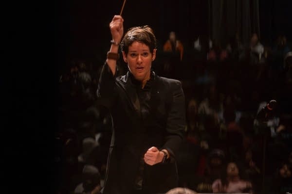 music director with hand raised
