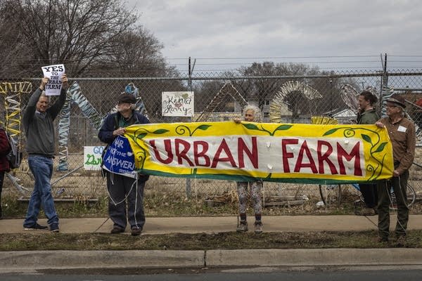People hold signs during an Earth Day march.