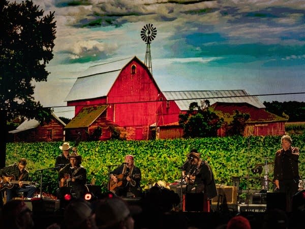 A group of musicians perform on the Farm Aid stage.