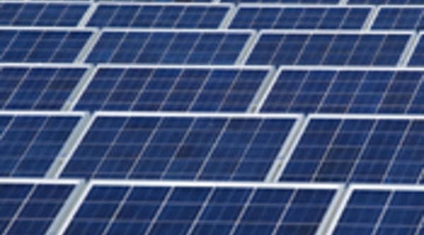 A technician checks the panels of a solar power system on the roof of solar power company in Frankfurt, Germany.