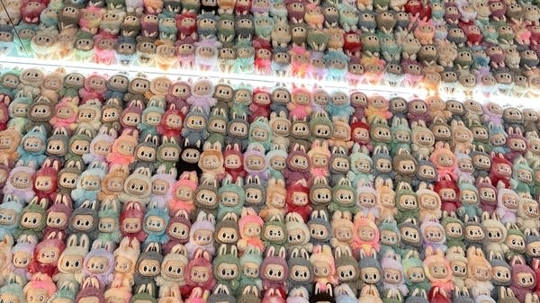 Labubu dolls on display at Pop Mart’s “The Monsters 10th Anniversary World Tour” in New York City. The fuzzy dolls are popular collectible items among adults.