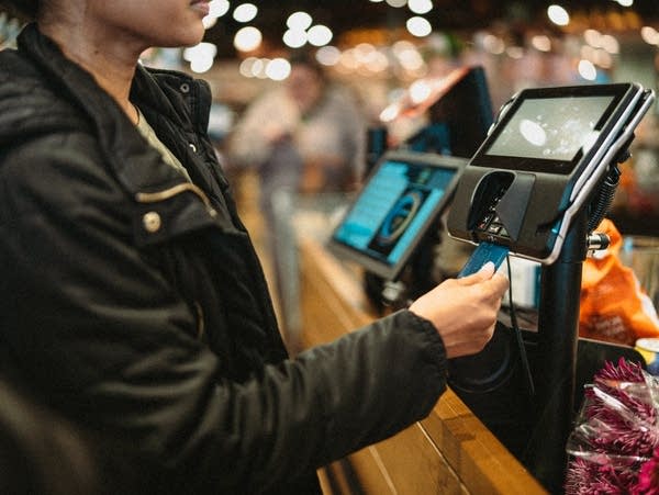 Woman paying for groceries at the supermarket