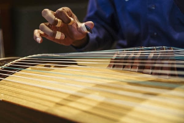 Jarrelle Barton uses finger picks to play the Guzheng,