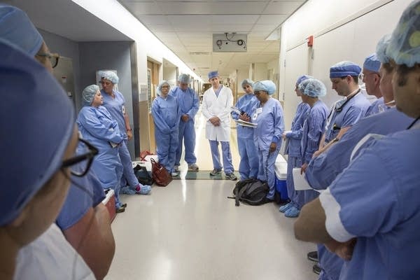 Doctors and nurses at gather before performing a face transplant