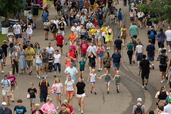 fairgoers walking down street 