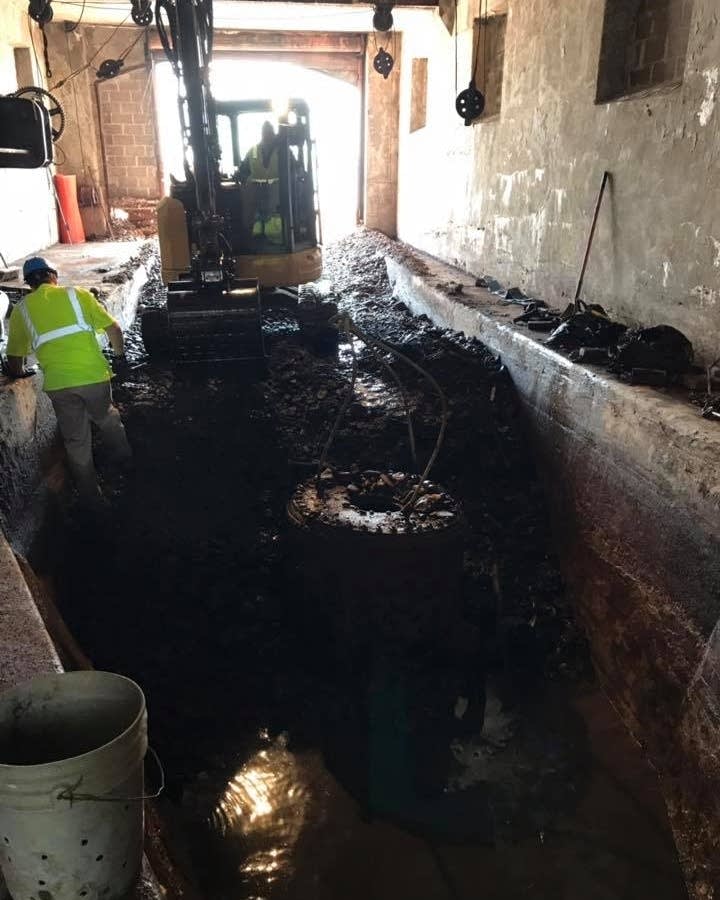 Crews excavate debris around the diving bell
