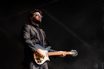 Dope Lemon performing on an outdoor stage.