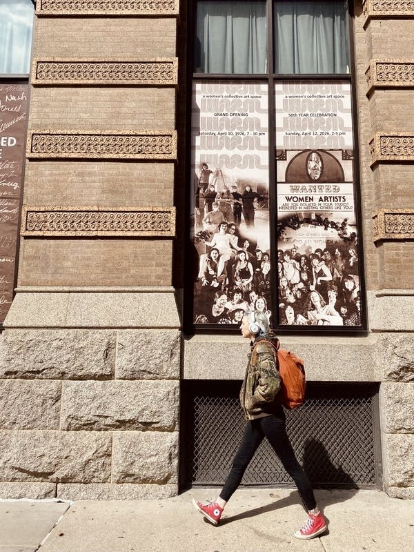 person outside walking past gallery