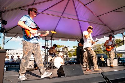 A band performing on an outdoor stage