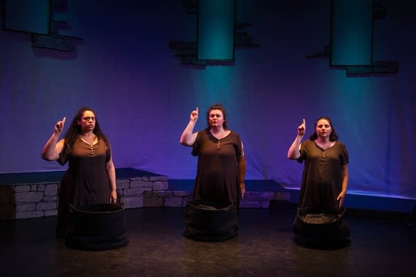 three people on stage