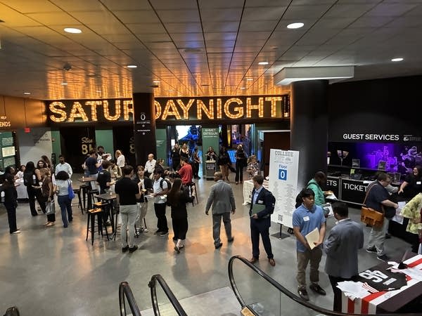 Hundreds of students enter and leave the Saturday Night Live exhibit at the Rock Hall, where job recruiters are scattered between displays.