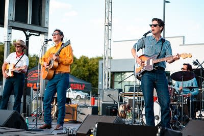 A band performing on an outdoor stage