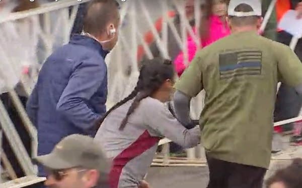 Marathoners carry runner to the finish line