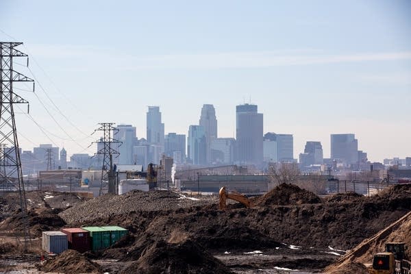 The Minneapolis skyline is seen beyond an industrial site.