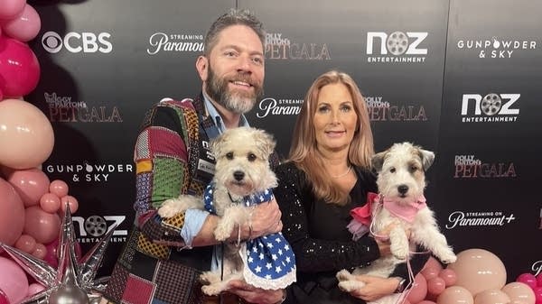 Pet talent agent Dawn Wolfe poses with her dog, Little Miss Hollywoof, and designer Cody Ratcliff on the set of the Dolly Parton Pet Gala. The production featured 18 trainers and 24 dogs.