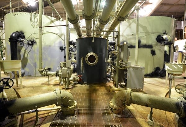 Water runs through sand filtration tanks and connecting pipes.