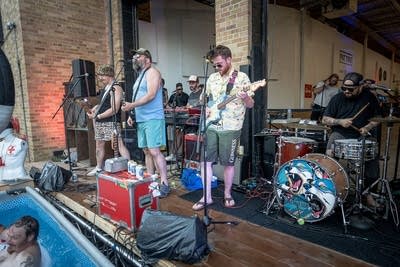 A band performing next to a pool at an outdoor event