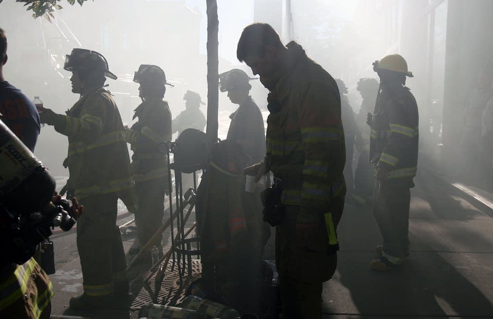 Winona firefighters gather on the sidewalk