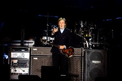 Paul McCartney performing on stage