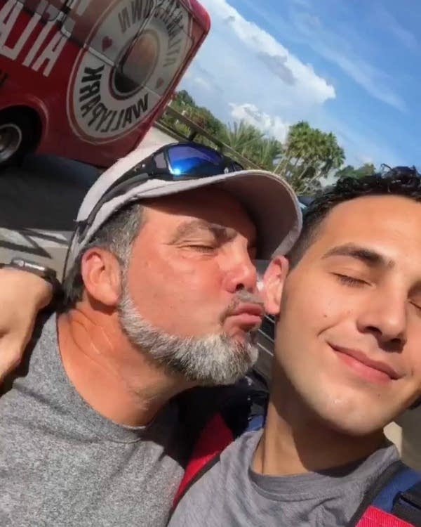 Two people pose for a fun selfie photo.